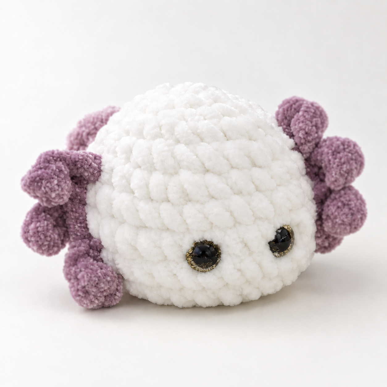 A small handmade crochet axolotl