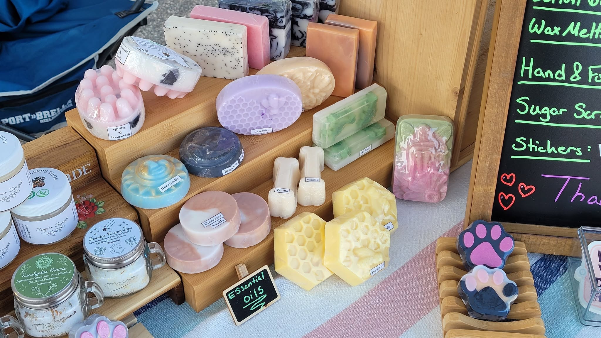 A market table display of assorted handmade soap bars