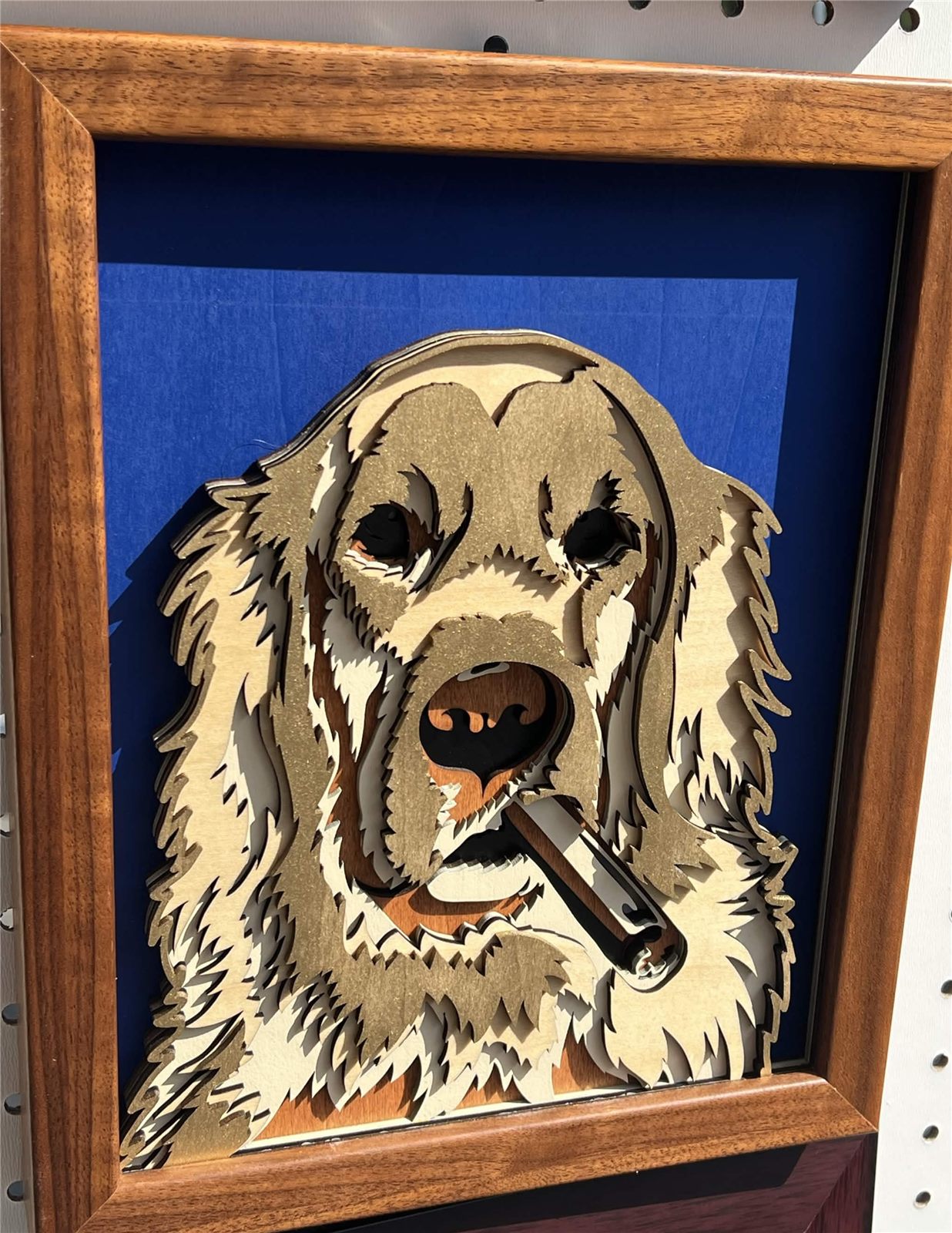 Layered wood art of a golden retriever with a cigar